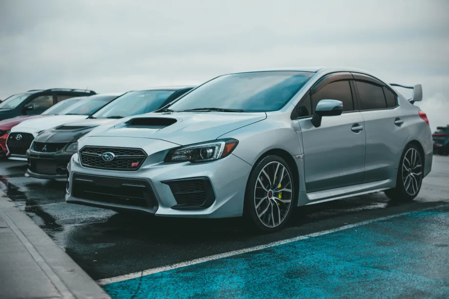 Silver Subaru STI parked in lot.