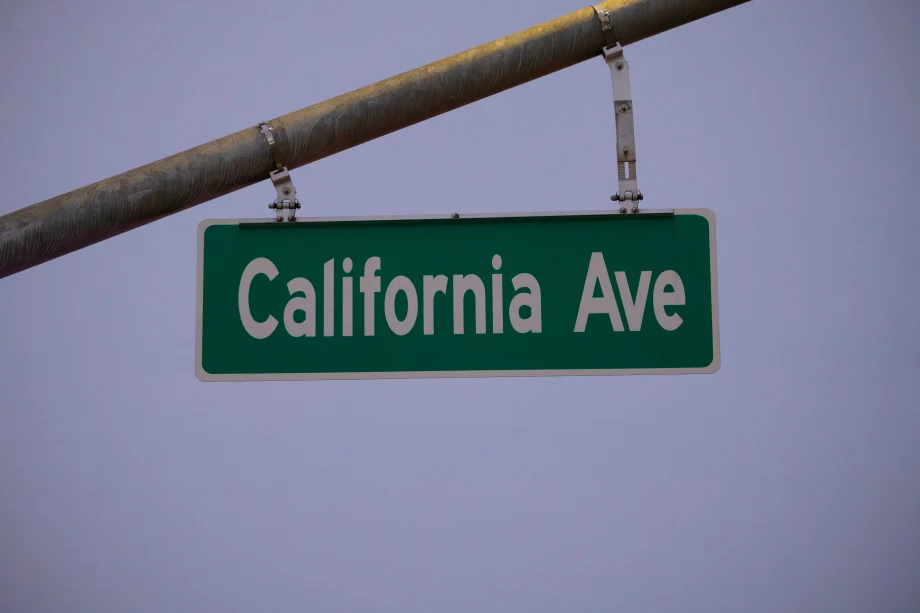 Green road sign that says California Ave