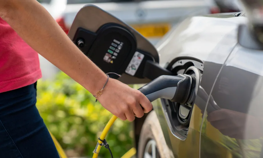 Person pumping gas into car.