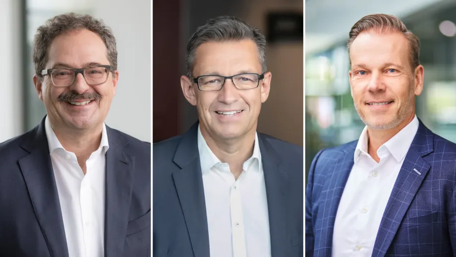 Three men smiling for headshots