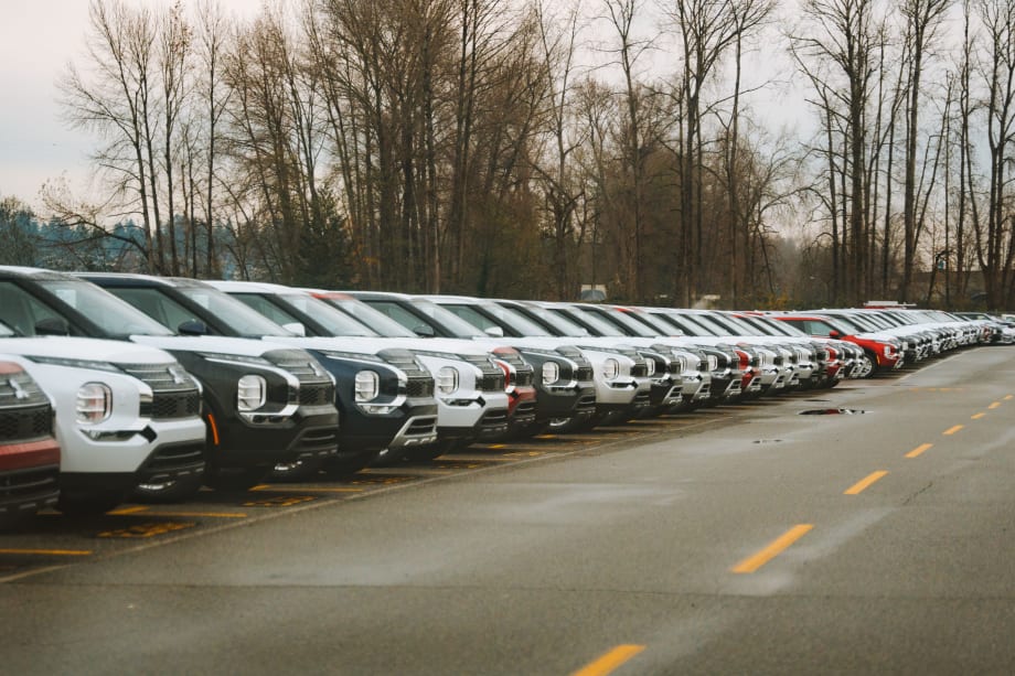 Line of eclipse SUVs in parking lot.