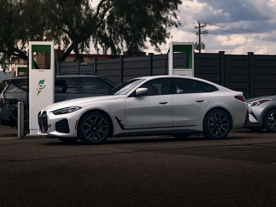 White electric vehicle parked at charging station.