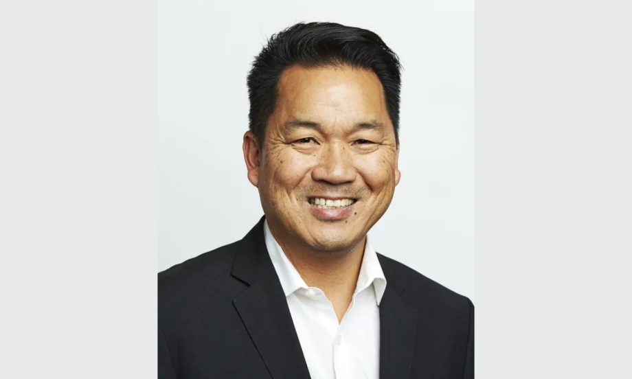 Asian man in black suit with white collared shirt