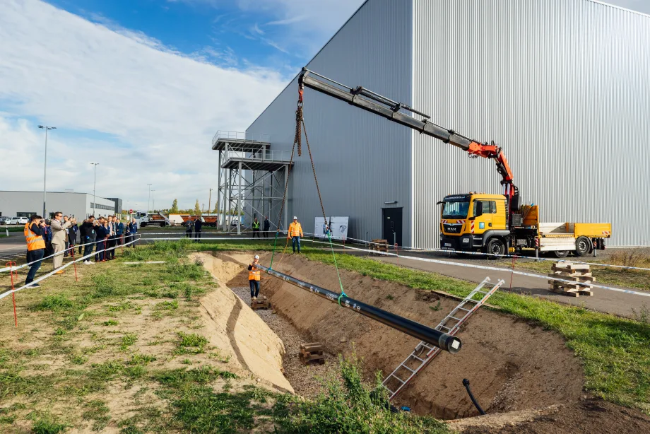 crane lowering a pipeline into the ground