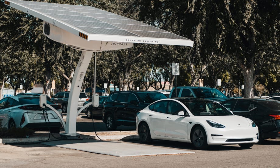 white electric car charging at an outside port