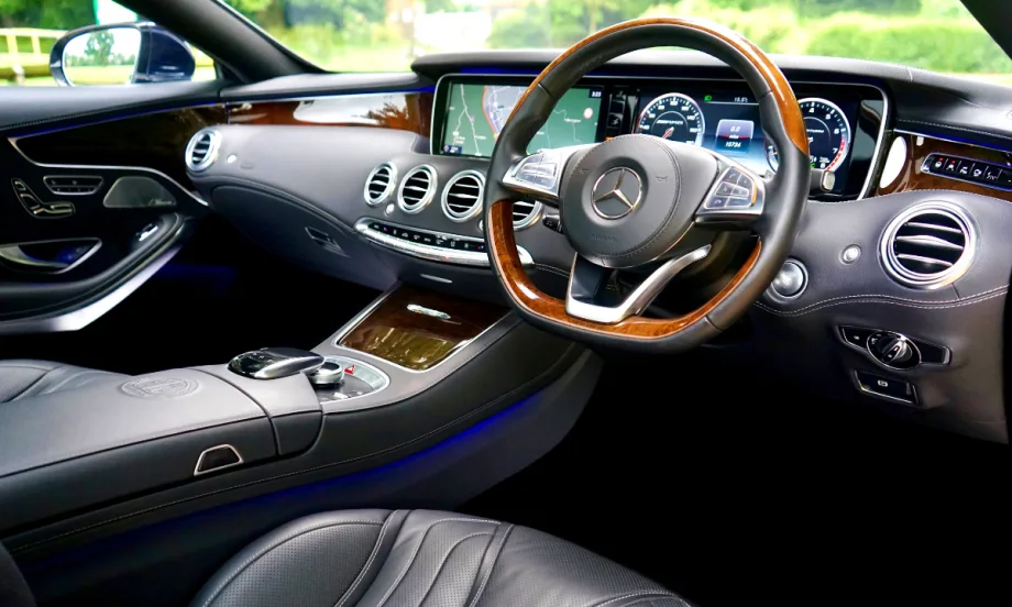 interior view of car dashboard and steering column. gray interior