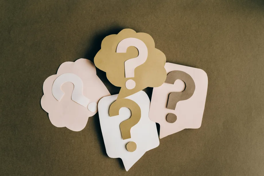 Several illustrations of question marks on a surface