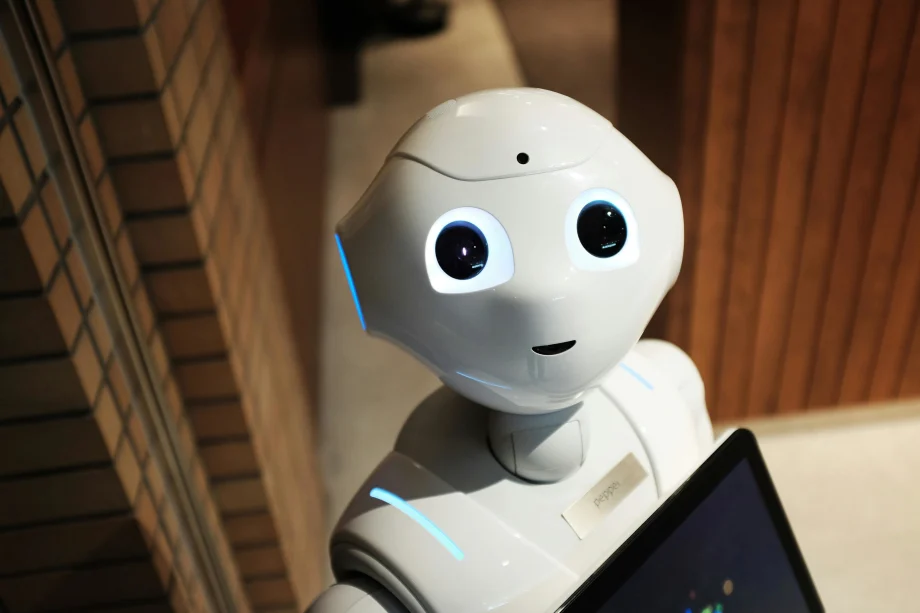 Photo of robot holding a laptop