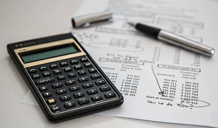 Photo of document next to calculator and inkpen