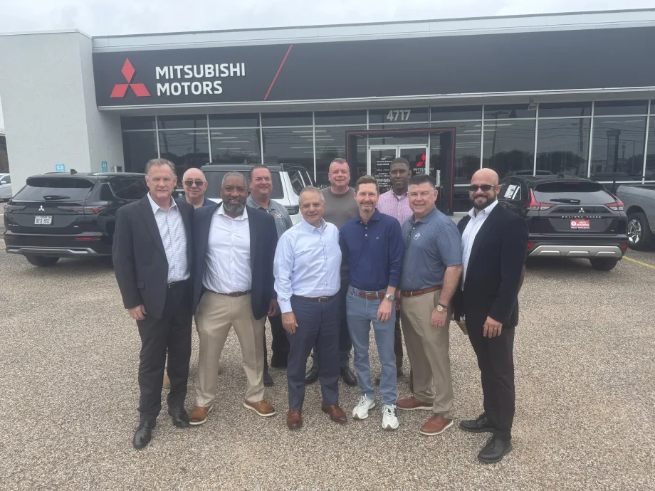 Photo of buyer and seller representatives in Waco Mitsubishi sale outside the dealership