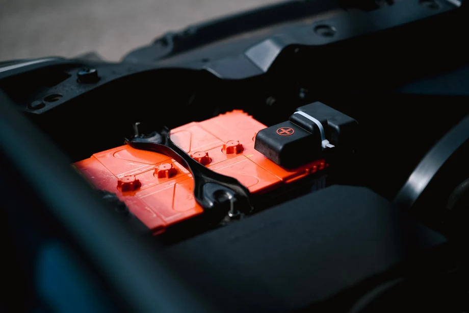 Closeup photo of an orange car battery