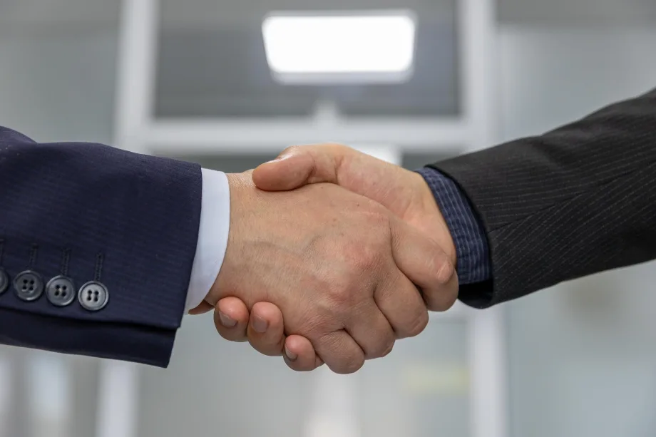 Two white men's shaking hands