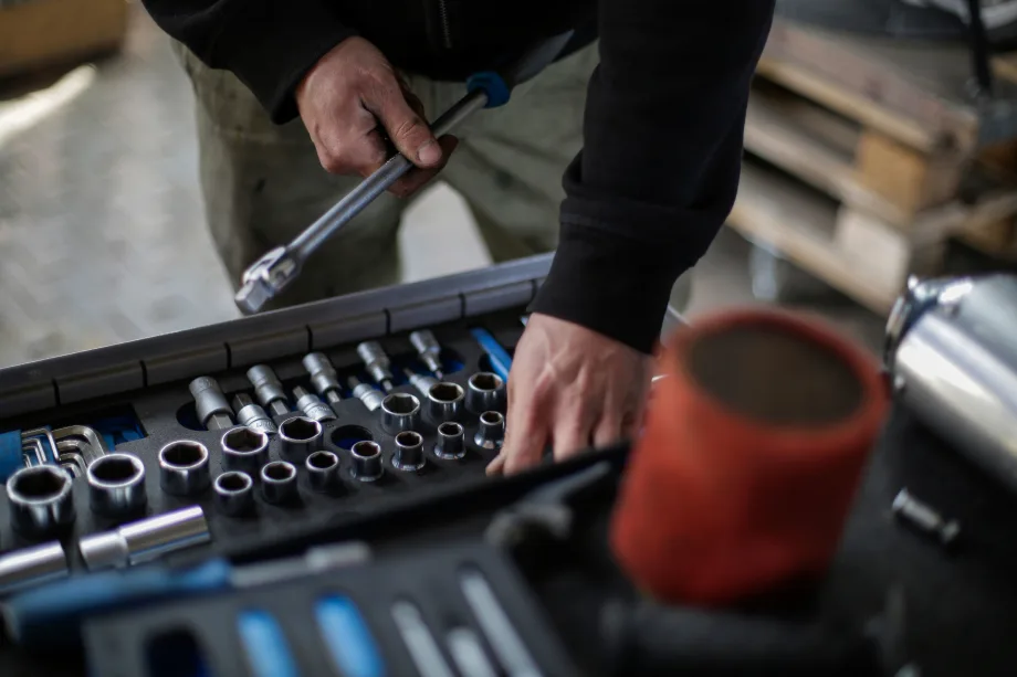 Mechanic's hand picking through a toolbox