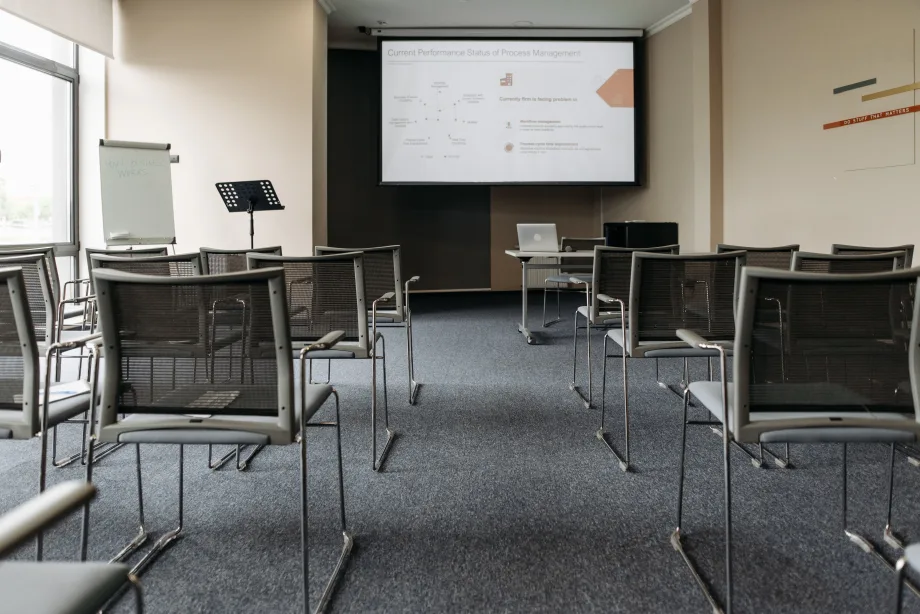Empty classroom with lecturn, chairs and video proejction screen