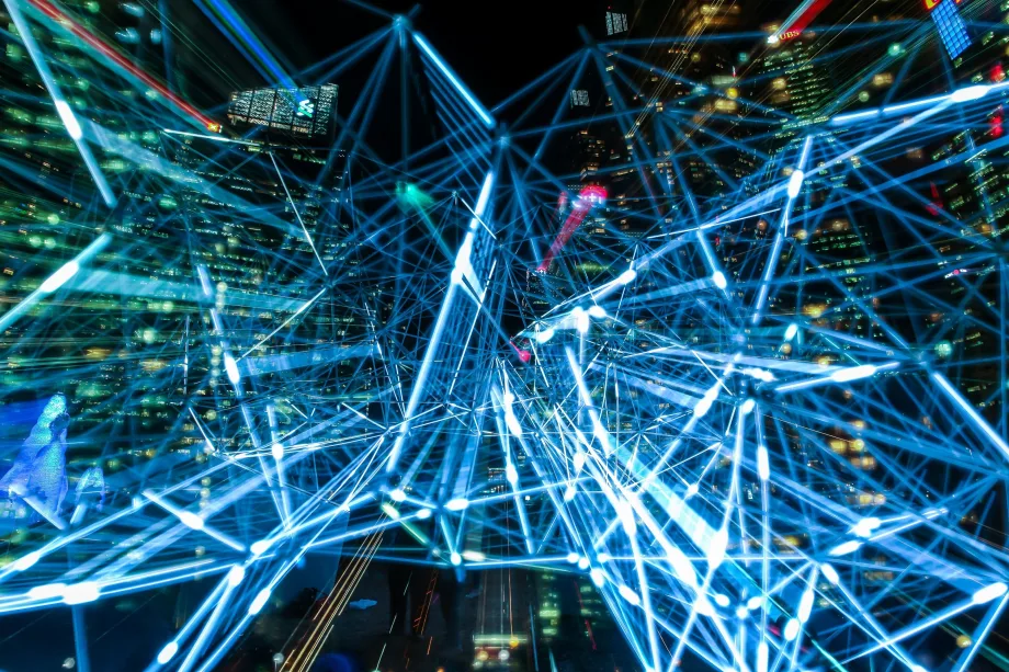 LIght trails with nighttime cityscape in background
