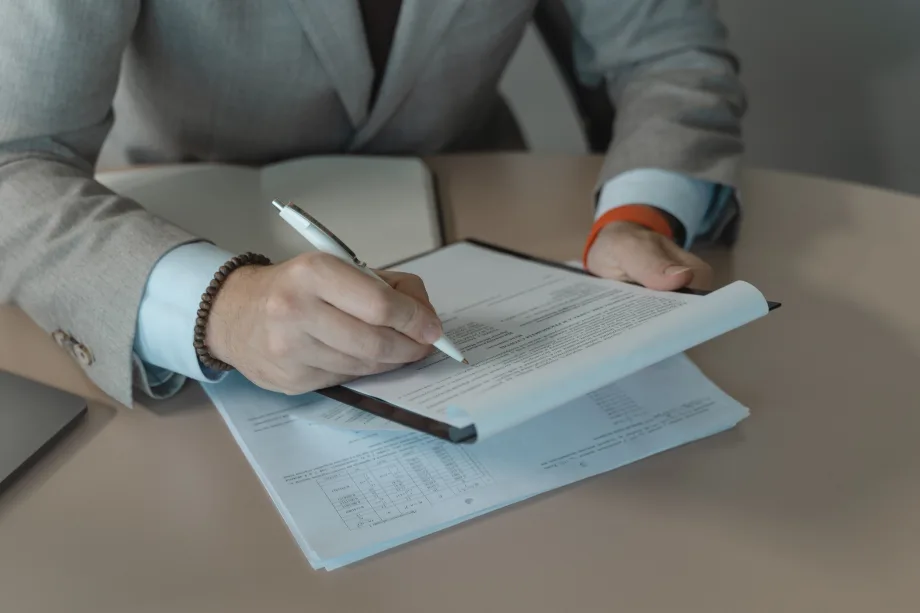 Businessman signing document with pen